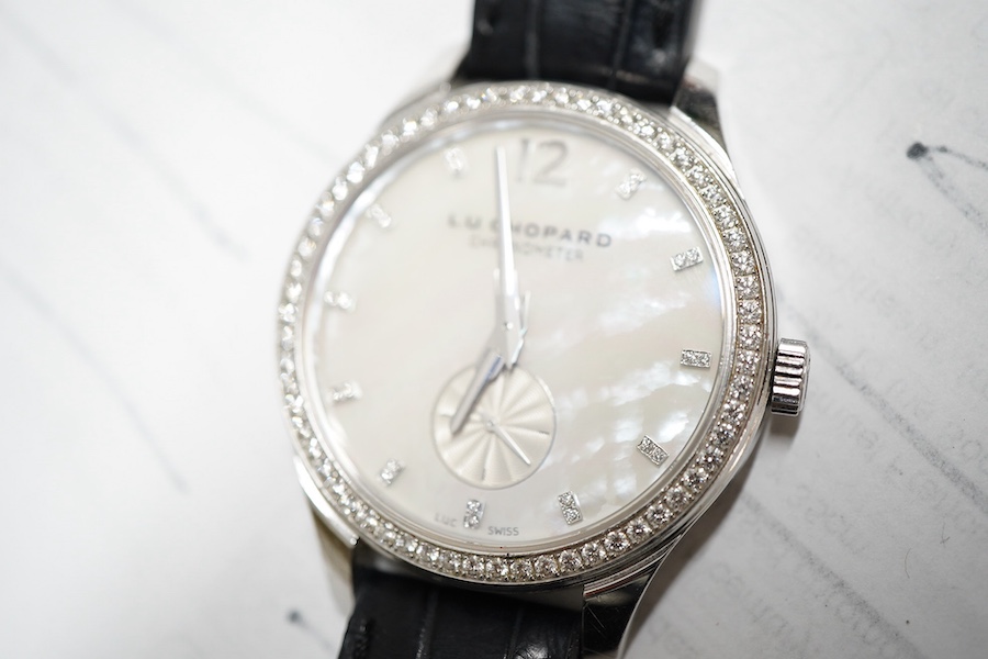 A gentleman's recent 18k white metal L.U. Chopard automatic chronometer wrist watch, with mother of pearl dial, diamond dot markers and subsidiary seconds, the bezel set with small brilliants, case diameter 35mm, movemen
